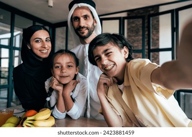 Traditional arabian family from Dubai spending time together at home. Concept about, emirati culture, parenthood, adoption and  family lifestyle - Powered by Shutterstock