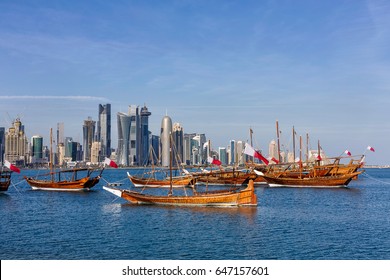 Traditional Arabic Dhow boats with Qatar flags in Doha, Qatar National day preparation. Doha, Qatar, Middle East.