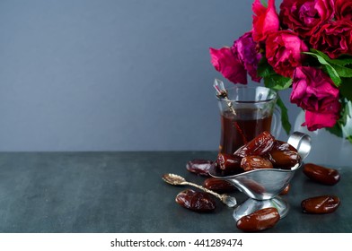 Traditional Arabic Tea Set And Dried Dates. Roses In The Background