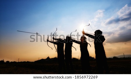 Traditional Archery Practice at the sunset by group