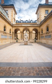 Traditional Architecture In A Beautiful Ancient Courtyard Of The College De France, Near The Sorbonne In Paris, France. Photo Taken From Public Sidewalk. Vertical