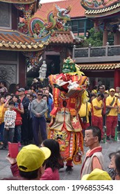 Traditional Asian Festival Parade With Colorful Costumes, Masquerade, Dance Performance In Religious Celebration Ceremony At Taiwanese Hotsu Longfong Temple, Miaoli City, Taiwan, Asia. April 15, 2018.