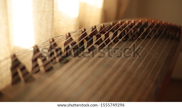 traditional asian music\
instrument wood guzheng. China Guzheng. stringed instrument. far\
east music.