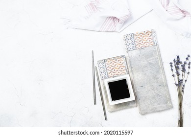 Traditional Asian Table Setting With Sushi Chopsticks, Long Ceramic Plate, Soy Sauce In A Bowl On Light Marble Table With Copy Space For Your Design. Asian Restaurant Menu Template.