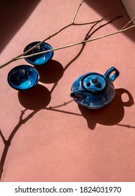 Traditional asian tea ceremony concept. Blue teapot and tea cups on brown background. Copy space. 