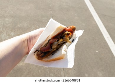 A traditional Australian barbequed sausage in bread with onions and tomato sauce 