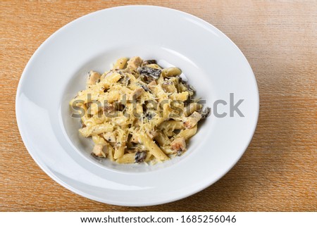 Traditional authentic italian penne al pollo e funghi pasta with mushroom ,chicken and parmesan cheese.