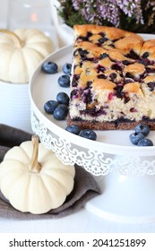 Traditional Autumn Blueberry Seasonal Cake And Table Decoration With White Baby Boo Pumpkins. 