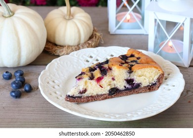 Traditional Autumn Blueberry Seasonal Cake And Table Decoration With White Baby Boo Pumpkins. 