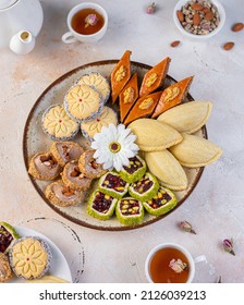 Traditional Azerbaijan holiday Novruz background traditional azerbaijan sweets,shekerbura, paxlava and different nuts and sweets,top view,space for copy