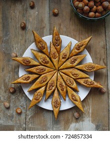 Traditional Azerbaijan Holiday Nowruz Cookies Baklava On White Plate On The Rustic Background With Nuts And Huzelnuts On Green Plate ,flat Lay