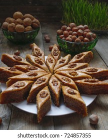 Traditional Azerbaijan Holiday Nowruz Cookies Baklava On White Plate On The Rustic Background With Nuts And Huzelnuts On Green Plate ,flat Lay