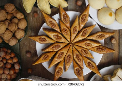 Traditional Azerbaijan Holiday Nowruz Cookies Baklava On White Plate On The Rustic Background With Nuts And Huzelnuts On Green Plate ,flat Lay