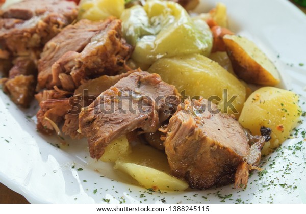 Traditional Balkan\
dish - meat stewed in a special pot, sac, and served with kajmak\
cheese and stewed\
vegetables