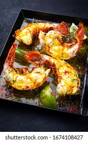 Traditional Barbecue Spiny Lobster Tail Sliced And Offered With Saffron Lemon Sauce As Closeup In A Metal Tray 