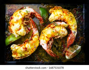 Traditional Barbecue Spiny Lobster Tail Sliced And Offered With Saffron Lemon Sauce As Top View On A Metal Tray 