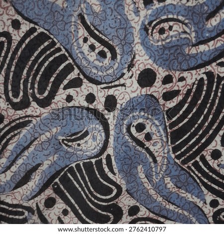 Traditional batik pattern featuring stylized blue bird motifs with intricate ornamental details on textured fabric. Cultural textile design with repeating elements, representing heritage, craftsmanship, and decorative artistry.