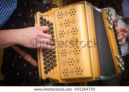 Traditional Bavarian accordion player playing folk music in Austria