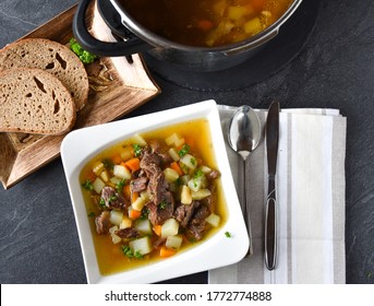 Traditional Beef Meat Soup With Root Vegetables. Fresh And Homemade Cooked. Served On A Plate With Rustic Bread.