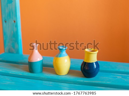 Image, Stock Photo A vase with colorful flowers stands on a landing. The wall of the house in the background is painted green.