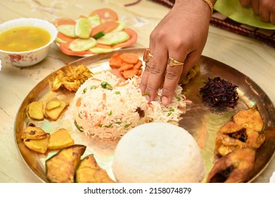 Traditional Bengali cuisine and food meal thali of West Bengal, India. Bengali food thali in kolkata. bengali thali for puja and Pailaboishakh. popular food kolkata. human hand.
 - Shutterstock ID 2158074879