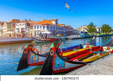 Traditional boats on the canal in Aveiro, Portugal. Colorful Moliceiro boat rides in Aveiro are popular with tourists to enjoy views of the charming canals. Aveiro, Portugal. 