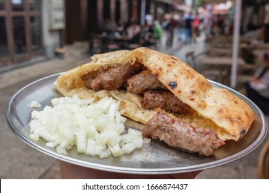 Traditional bosnian cevapi in Sarajevo, Bosnia and Herzegovina. Grilled dish of minced meat called cevapcici in buns