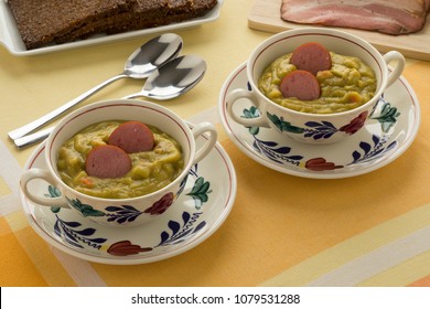 Traditional bowls with Dutch pea soup, bacon and rye bread