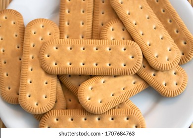 Traditional Brazilian corn starch biscuit called biscoito de maizena. Tipical cookie for afternoon coffee/tea. Corn starch biscuit on white plate