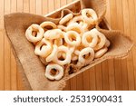 Traditional Brazilian starch biscuit, called polvilho biscuit in the basket. close up view