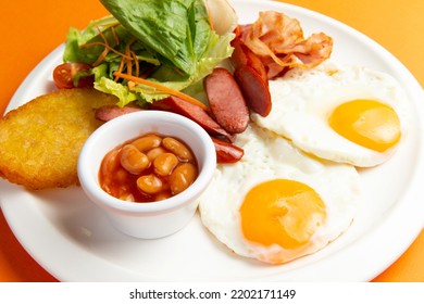 Traditional Breakfast. Fried Sausage Eggs And Hash Brown In A Plate. Selective Focus.