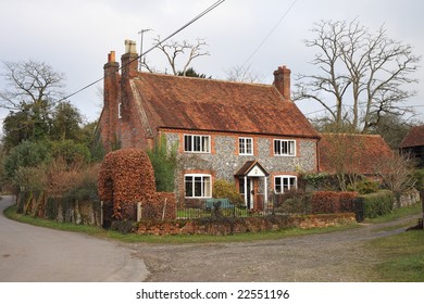 Traditional Brick and Flint English Rural Farmhouse and garden in Winter