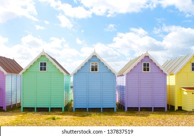 Traditional British Beach Huts On A Bright Sunny Day