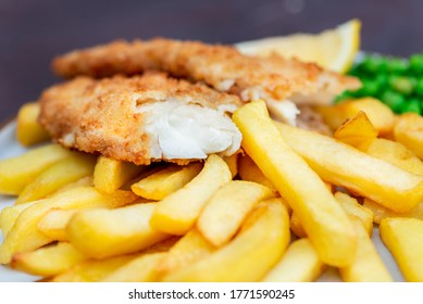 Traditional British Food such as Fish and Chips with green peas served in the Pub or Restaurant - Powered by Shutterstock