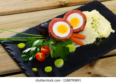 Traditional British Picnic Food - Delicious Scotch Egg Cut In Halves With Potato Mash, Vegetables And Greens