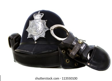 Traditional British Police Helmet And Handcuffs Isolated On White