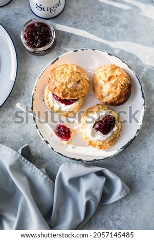 Traditional British Scones with clotted cream, raspberry jam.