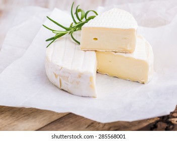 Traditional Camembert With Rosemary On White Paper