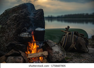 Traditional Camping Scene, Canoe And Campfire On A Back Country Lake In The Evening 