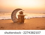 Traditional Candle light with Crescent moon shape on the beach, Ramadan Kareem background 2024