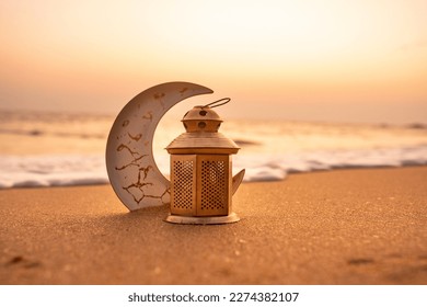 Traditional Candle light with Crescent moon shape on the beach, Ramadan Kareem baackground - Shutterstock ID 2274382107