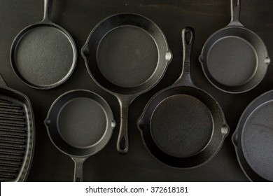 Traditional cast iron skillet on black wood table.