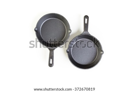 traditional cast iron skillet on a white background.