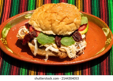 Traditional Cemita Poblana Prepared With Milanesa, Cheese, Avocado, Chipotle, Tomato And Bread. Icon In Mexican Food