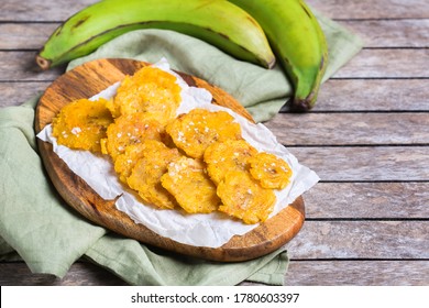 Traditional Central American caribbean cuban colombian food. Fried tostones, green bananas plantains with guacamole sauce. Top view, flat lay