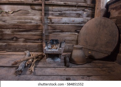 Traditional charcoal burning clay stove in a rustic wooden house. - Powered by Shutterstock