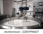 Traditional cheese making at a creamery, milk in a large stainless steel tanks. Copy space