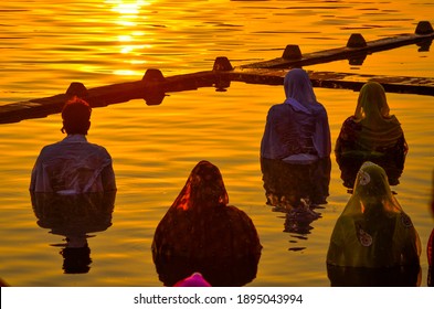 Traditional Chhath Pooja Performed Along The River Side By Man And Women 