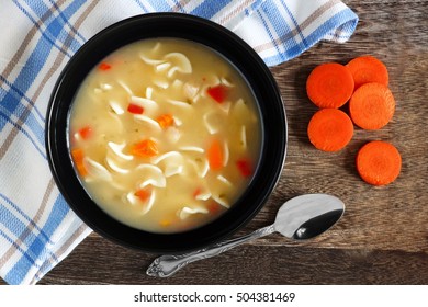 Traditional Chicken Noodle Soup, Overhead Scene On A Rustic Wood Background