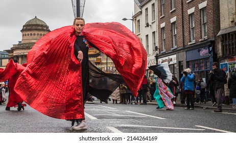 Traditional Chinese dancing being performed by a young adult during the Chinese New Year celebrations in Liverpool's Chinatown district in February 2022.